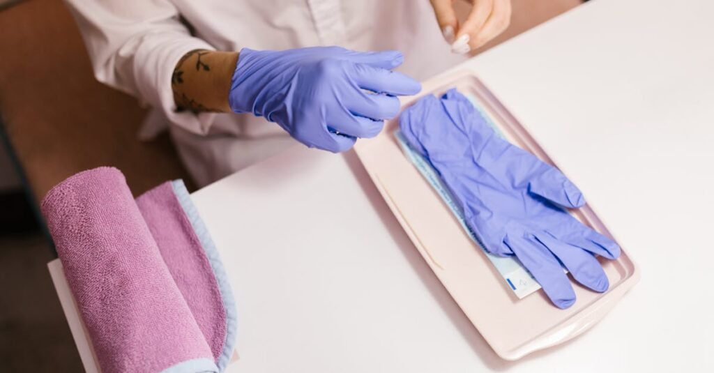 Close-up of gloved hands preparing a sterile setup for a salon or spa session.